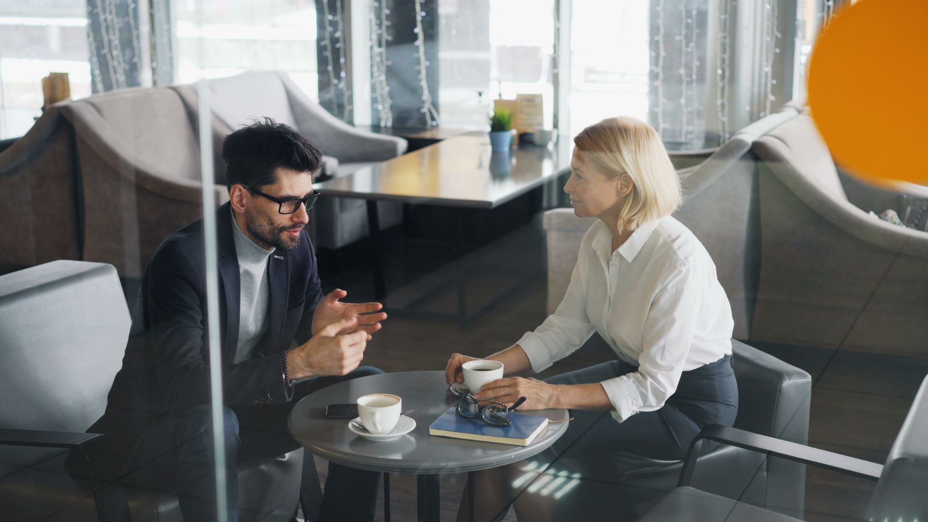 Business professionals discussing work in a modern office